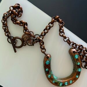 Beautiful “Antiqued” horse shoe necklace with turquoise stones.